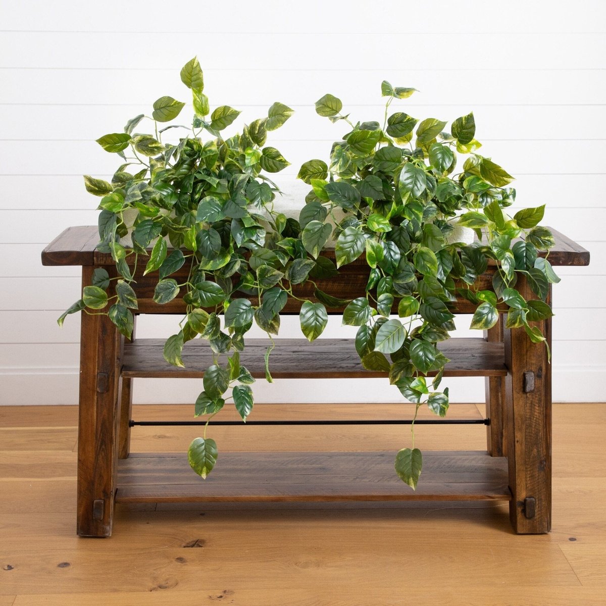 36-inch UV Resistant Artificial Pothos Hanging Plant – Set of 2 displayed on wooden bench