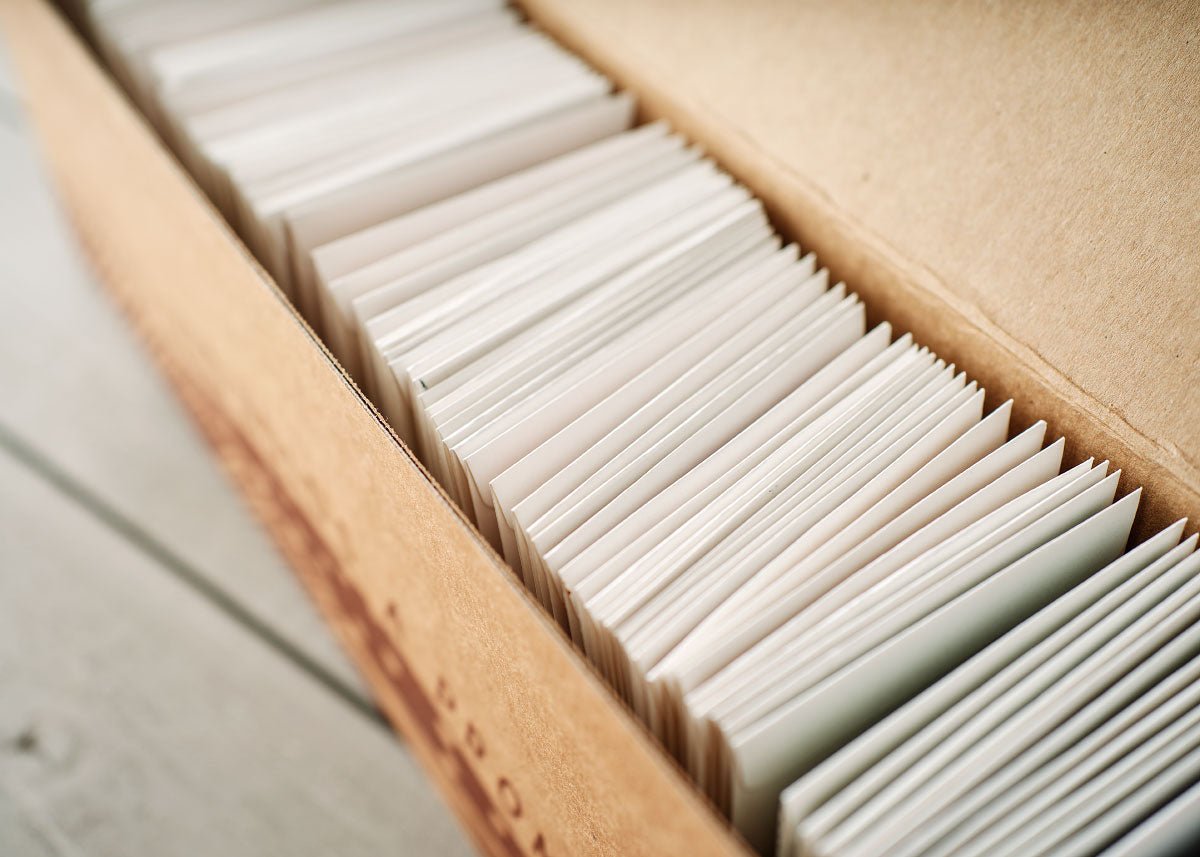 Box of organic seed packets on a wooden surface