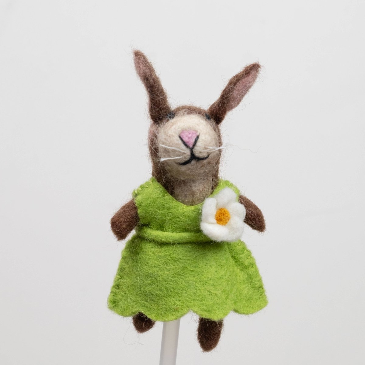 Handcrafted rabbits finger puppet made from natural wool, featuring outfits against a white backdrop