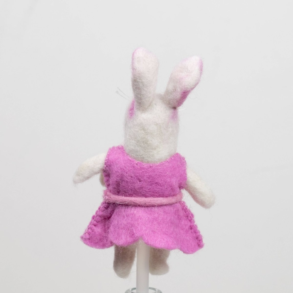 Handcrafted rabbits finger puppet made from natural wool, featuring outfits against a white backdrop