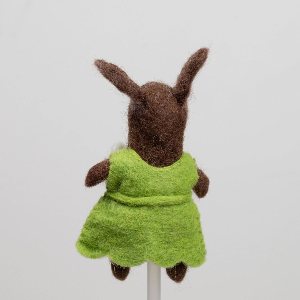 Handcrafted rabbits finger puppet made from natural wool, featuring outfits against a white backdrop