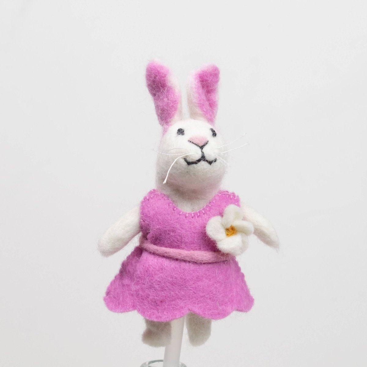 Handcrafted rabbits finger puppet made from natural wool, featuring outfits against a white backdrop