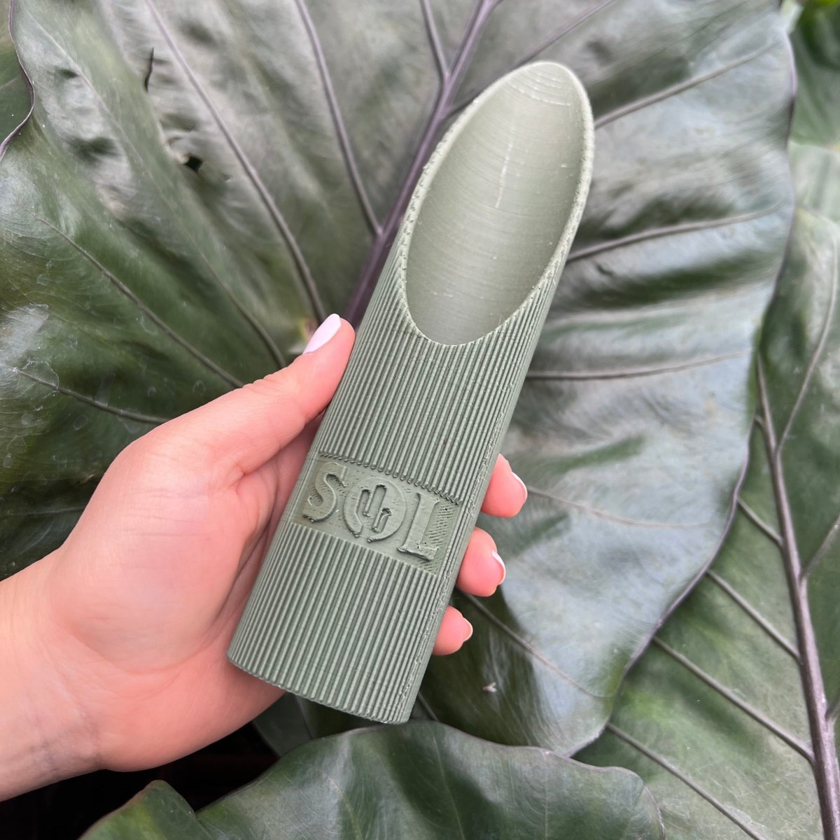 Large Soil Scoop by Sol Soils in Hand with Alocasia Background - Ed's Plant Shop