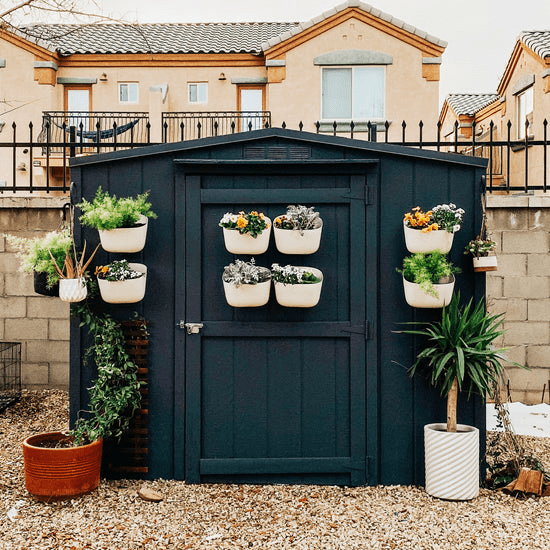 Oat-colored WallyGrow wall planter with trailing greenery