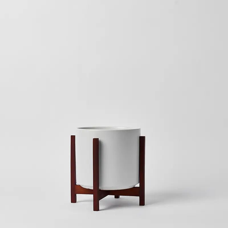 White planter with wooden stand on a light gray background
