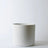 White ceramic planter on a light gray background
