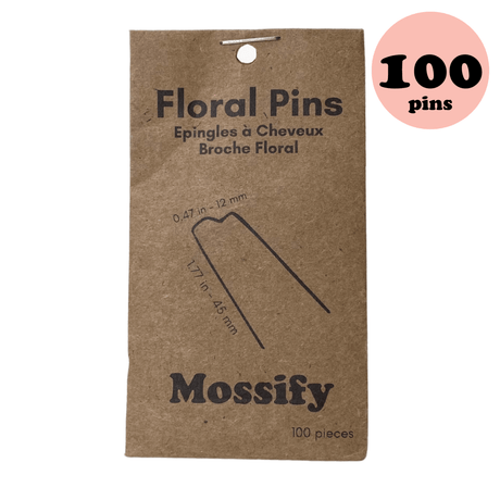 Kraft paper packaging for floral pins with 'Mossify' branding and a count of 100 pins.