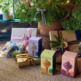 Gifts and 'Watering Bulb' boxes under a decorated Christmas tree.