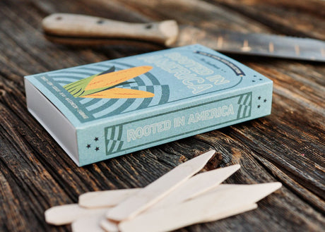 Matchbox-style heirloom seed collection featuring 6 historic American vegetable varieties with white birch garden markers