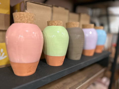 Assorted terracotta Ollas buried in garden soil, showing self‑watering irrigation